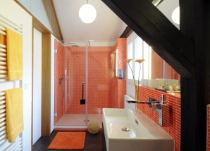 Oranges Glasmosaik und dunkles Holz geben den Ton an.