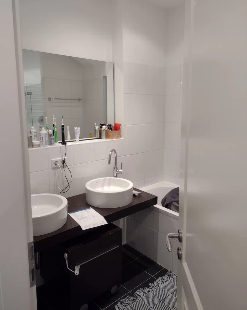 Badezimmer vor der Renovierung- Dunkle Akzente und kompakte Gestaltung